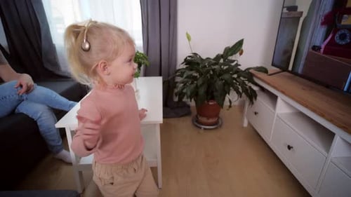 A Girl with a Cochlear Implant Watches TV and Hears Sounds