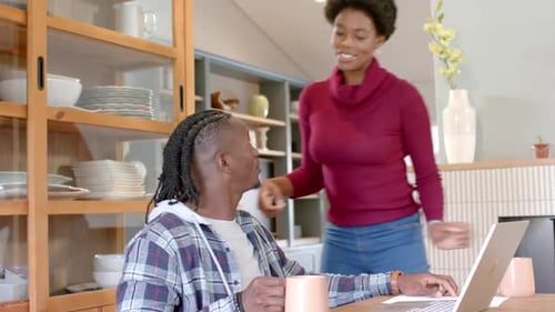 Young Couple Working Together at Home on Laptop