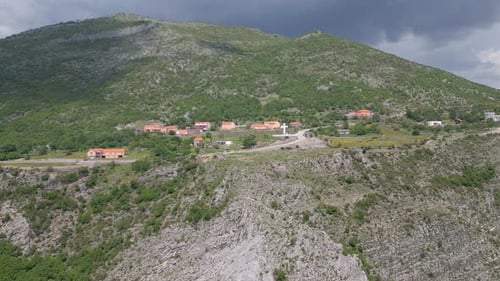 European village against the backdrop of a beautiful mountain panorama. Aerial view.