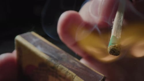 Hands Lights a Match with a Green Sulfur Head Slow Motion Strikes a Match on the Side of the Box