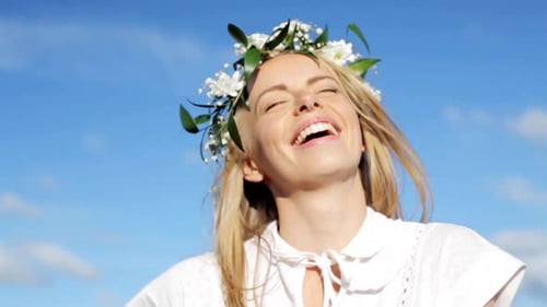 Smiling woman with flower crown enjoys sunshine