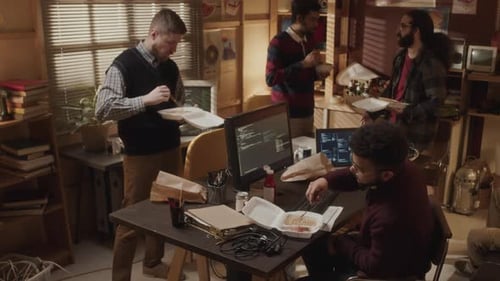 Young Adults Enjoying Lunch at Office Desks