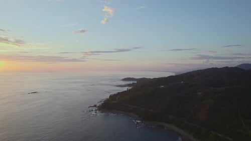 Incredible drone pan from rocky uninhabited coast to fantastic evening sunset