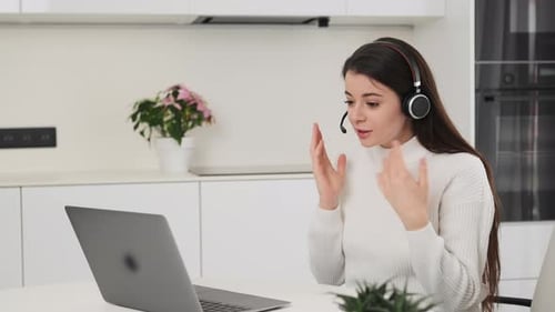 Woman Video Calling With Laptop In Modern Kitchen