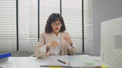 Frustrated Asian young businesswoman overwork late in office workplace.