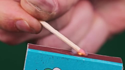 Lighting a Match with a Matchbox Close Up