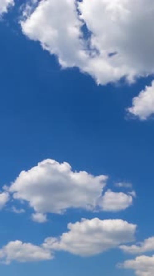 Soft beautiful clouds forming in the blue sky. Clouds flying quickly in the rays of sun. Timelapse