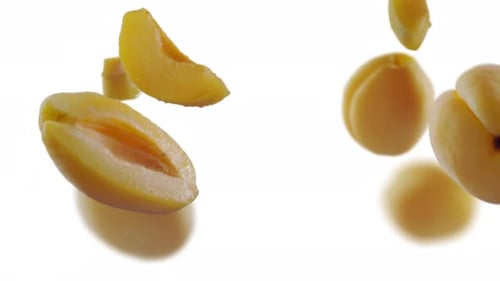 Flying Apricot and Apricots Slices in White Background