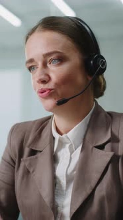 Woman With Headset Speaking in an Office