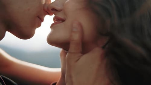 Extreme Close Up View of a Young Couple Beautifully Passionately Kissing Each Other at Sunset, in