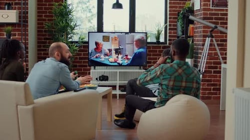 Multiethnic Group of Friends Watching Movie on Tv Channel