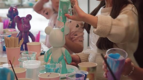 As crianças gostam de usar tinta brilhante para criar estatuetas durante as aulas de arte. Elas estão interessadas na