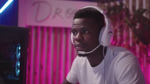 Young Man Plays Video Game with Controller