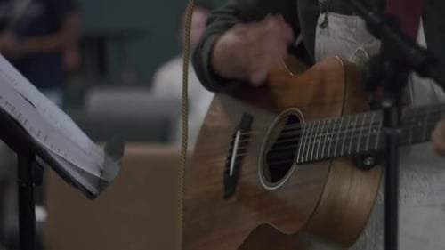 Cropped Image Of A Female Guitarist Strumming On An Acoustic Guitar At The Stage. close up