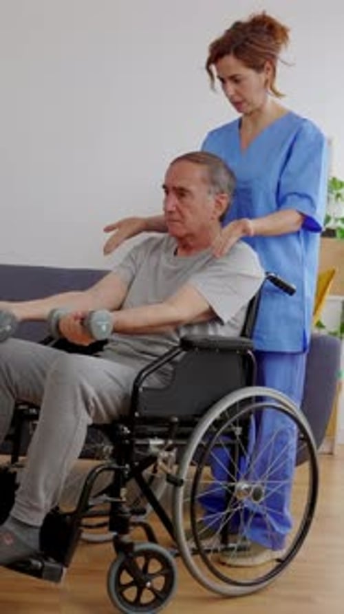Senior Man in Wheelchair Lifting Weights at Home