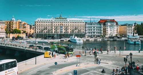 Stockholm Sweden Traffic With Cars And Buses Touristic Pleasure Boats Floating Near Famous Grand