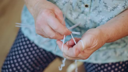 Elderly Woman Knitting Senior Seamstress Creating Intricate Stitches Closeup of Aged Woman Expertly