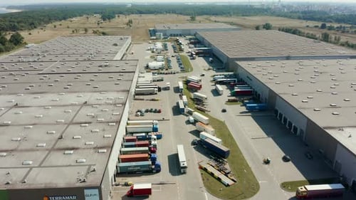 Aerial View of Logistic Park Warehouse with Trucks