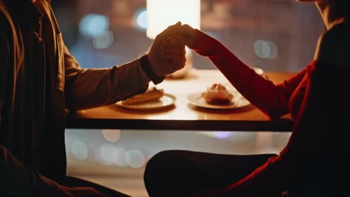 Tender Couple Holding Hands at Romantic Night Date in Restaurant Closeup