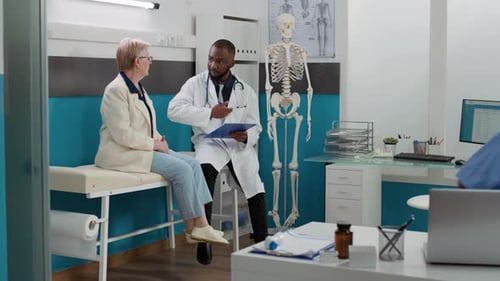 Doctor Examines Senior Woman in Hospital Office