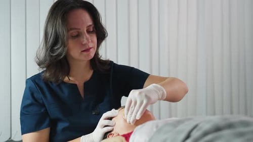 Wellness Technician Dipping Fingernail And Cradling Jawline During Spa Session