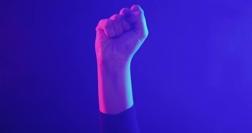Raised Hand in Fist in Neon Lighting