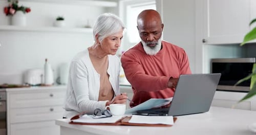 Senior couple, bills and documents on computer for home mortgage, budget planning