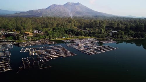 Aerial Footage of Floating Fish Farm Platforms on Calm Freshwater Lake in Rural Indonesia