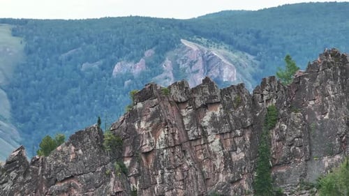 A Majestic Mountain Peak with an Impressive Rock Formation in the Foreground