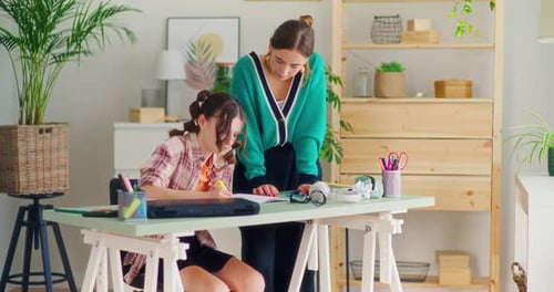 Teacher Explains a Difficult Task to the Student and Helps Her During the Lesson