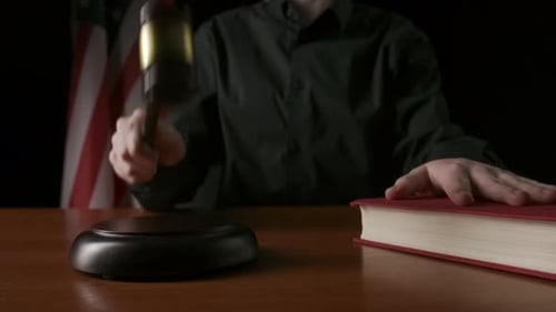 Judge Gavel Strike with American Flag Background