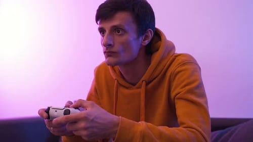 Young Adult Playing Video Game with Controller