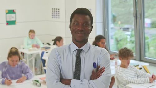 Smiling Teacher with Students in Bright Classroom