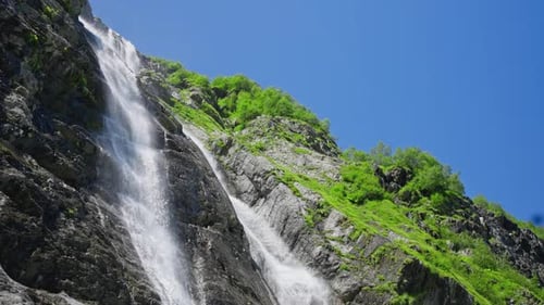 Streams of a Mountain Waterfall Falling Down