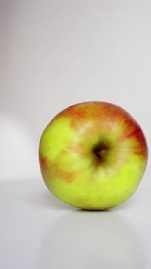 A Vibrant Green Apple is Shown Whole and Sliced Highlighting Its Vivid Colors and Interesting