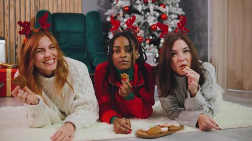 Young Women Enjoy Christmas Cookies Together