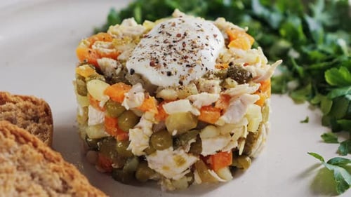 Salad with Chicken, Vegetables and Creamy Topping on Plate