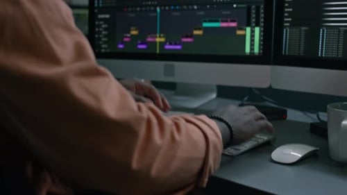 Adult Using Video Editing Software at Desk