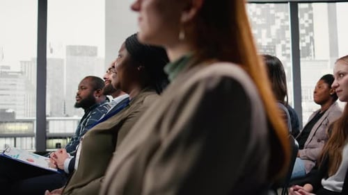 Diverse audience listening and applauding at corporate event