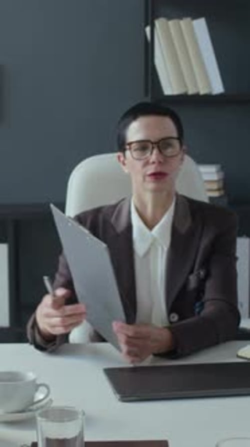 Businesswoman Presenting Data at Office Meeting