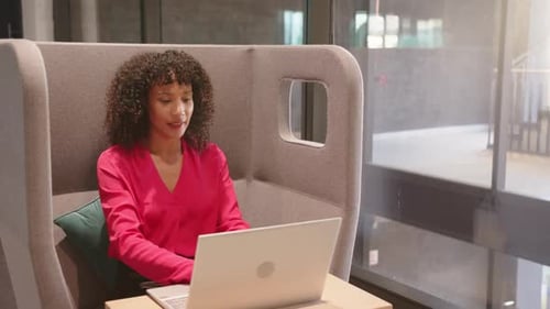 Stretching and relaxing, woman taking break from work with laptop in office