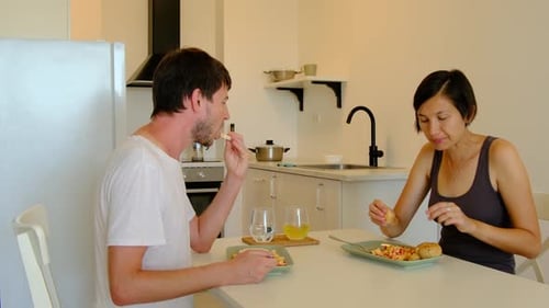 Couple Eating Meal Together in Modern Kitchen