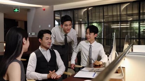 Diverse group colleagues of business professionals collaborate sitting on desk in modern office meet