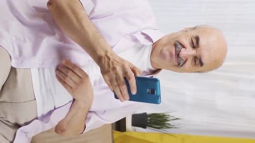 Senior Adult Using Smartphone at Home