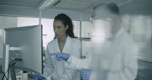 Scientists Analyzing Data on Computer in Modern Lab