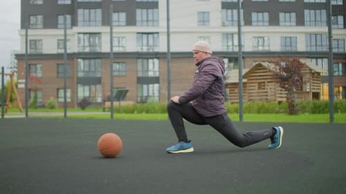 Man Warming Up Stretching Before Basketball Game