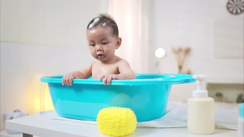 Adorable Baby Bath Time with Yellow Sponge