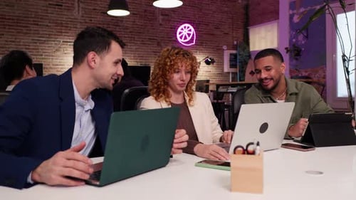 Coworkers Collaborating on Project in Modern Office Slow Motion
