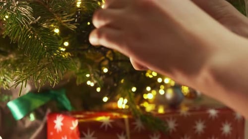 Decorating Christmas Tree With Ornaments Close Up