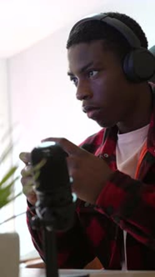 Young Adult Gaming with Controller and Headphones